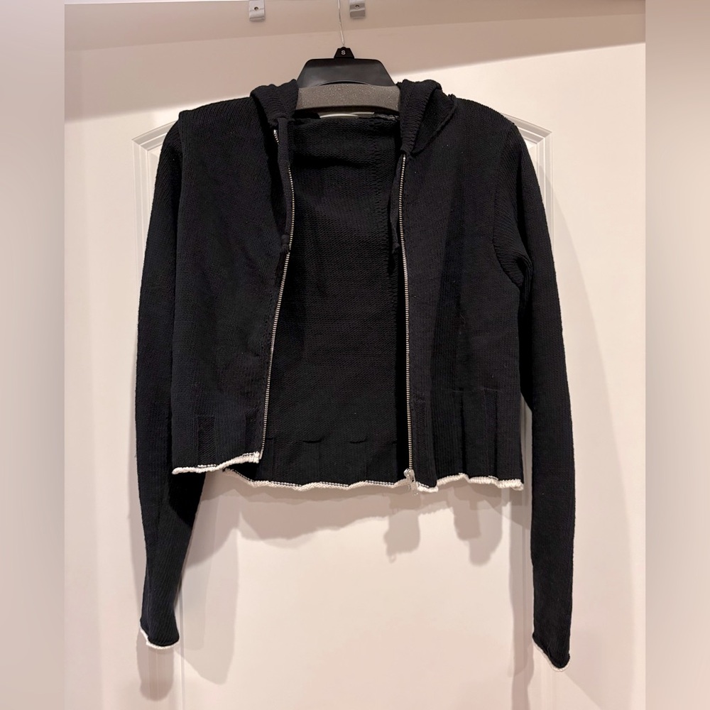 Brand New black with white trim sweater zip up with hood. Size Small